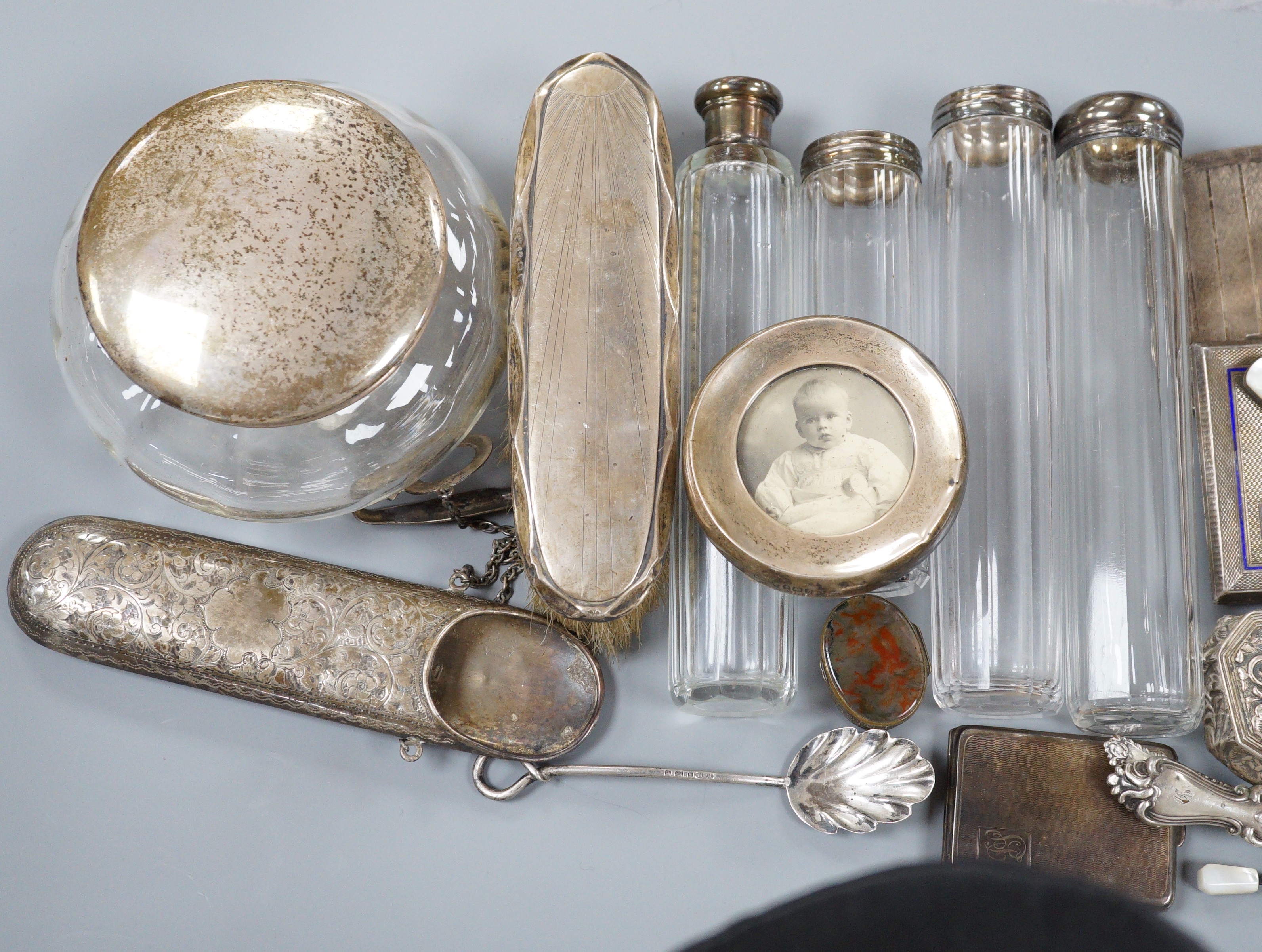 A collection of assorted collectable silver items, including a George V spectacles case, cigarette box, trinket box, Dutch spoon, mounted glass power jar, egg cup, enamelled cigarette case, vesta case, fruit knife, napki
